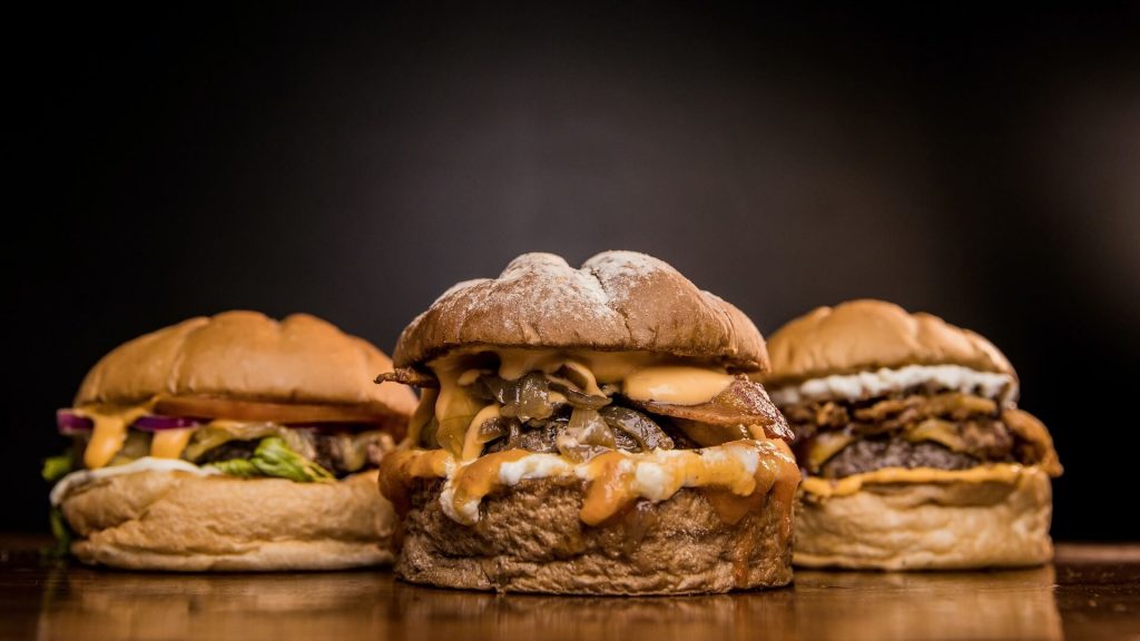 A photo of three burgers,a perfect example of processed food