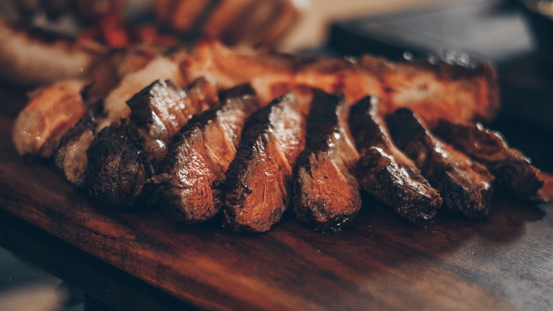 A close-up view of a beautifully cooked and sliced steak.